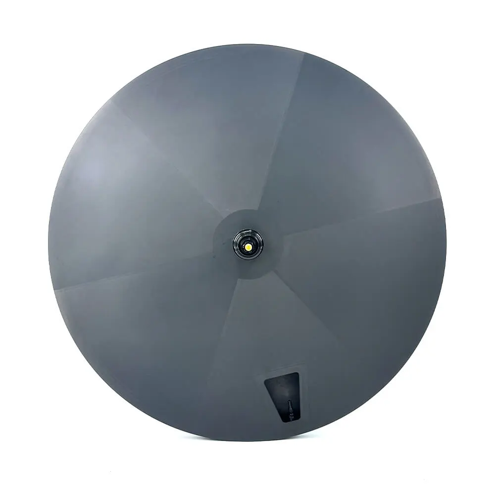 Matte black carbon disc wheel developed by Light Travel Cycling for time-trial builds, with segmented layup surface and valve cutout