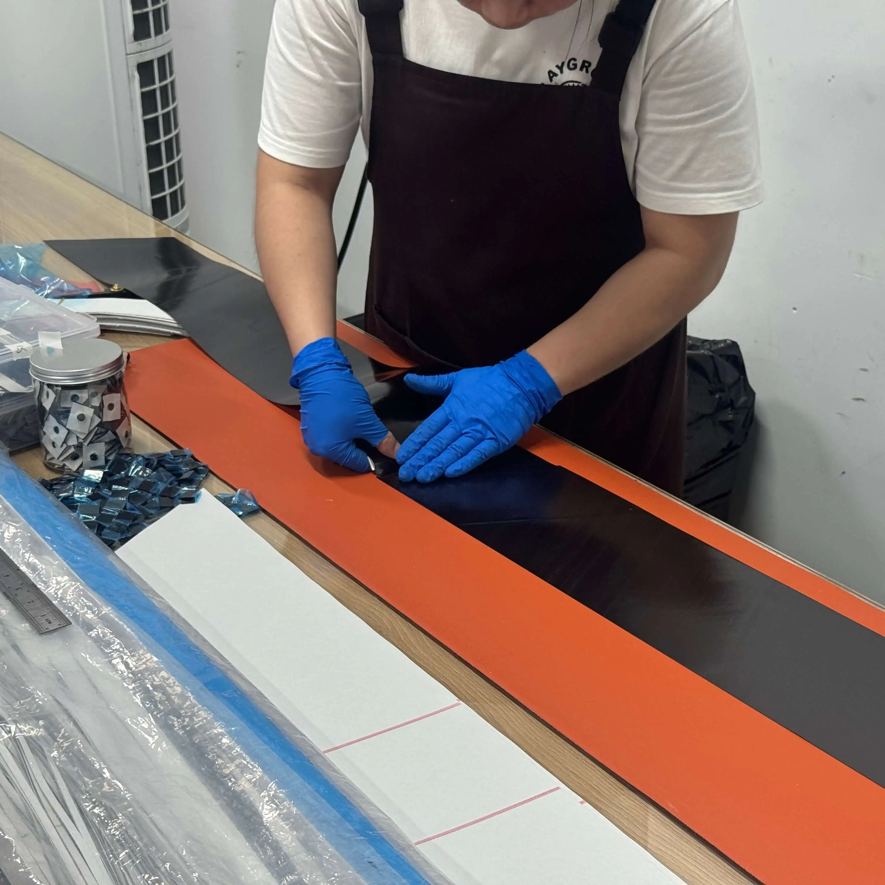 Laminator hand-laying carbon plies onto a rim molding tool at Light Travel Cycling